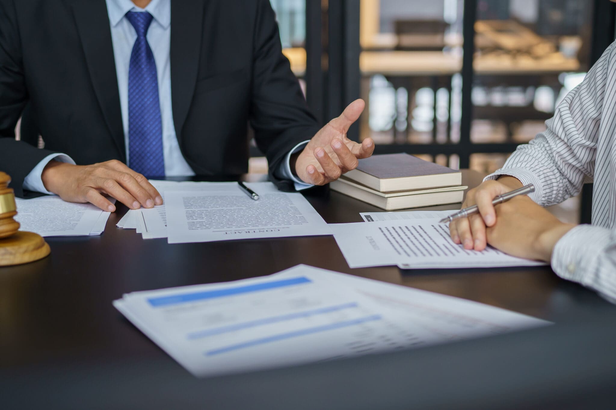 Lawyer and client reviewing contract.