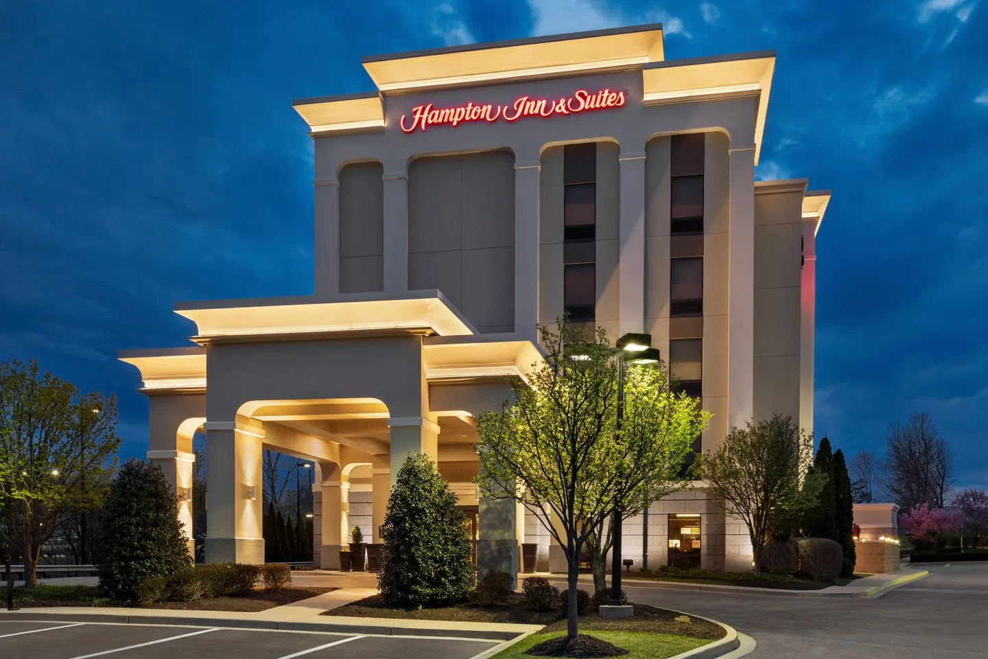 A hotel with a large building and trees