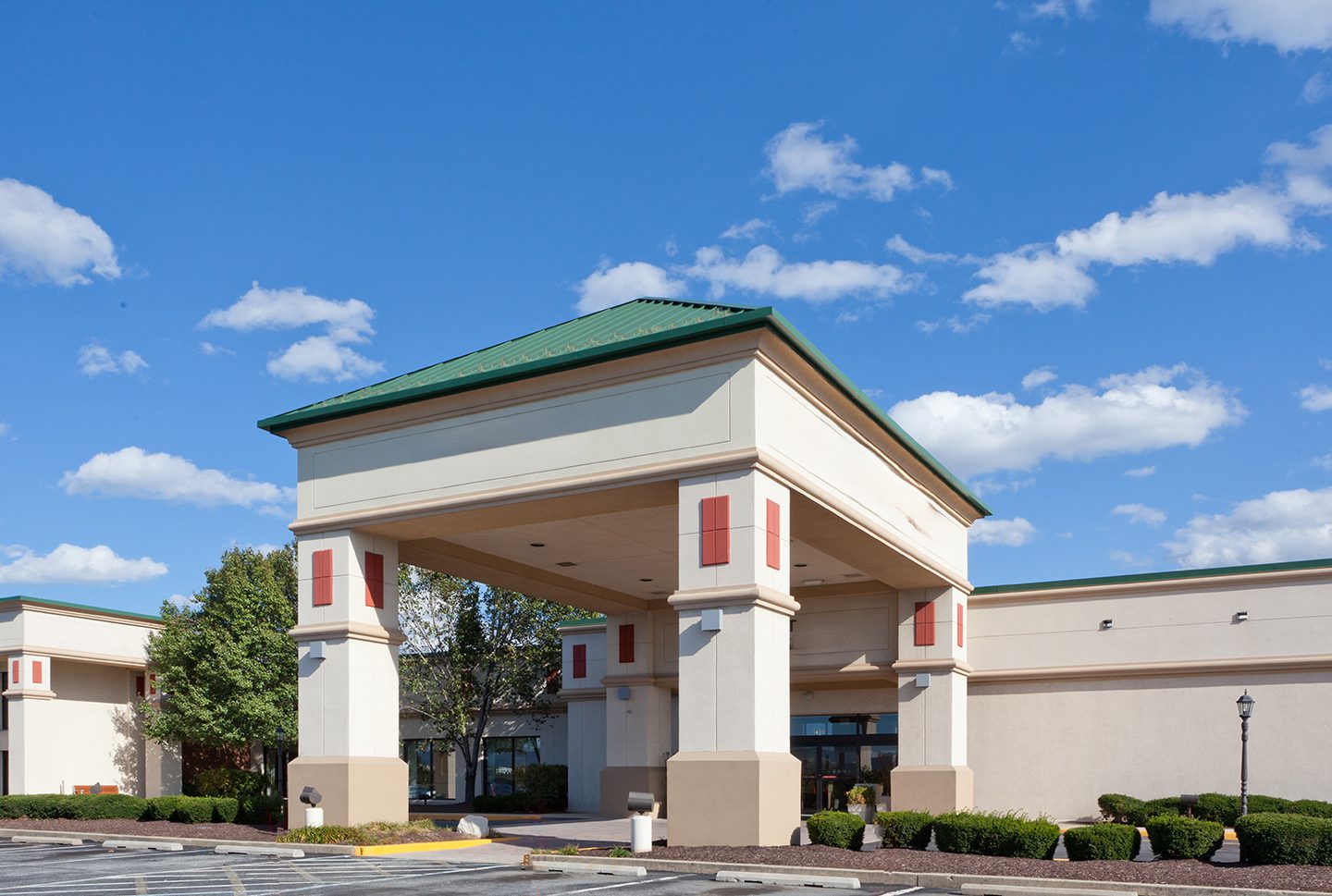 A large building with green roof and white trim.