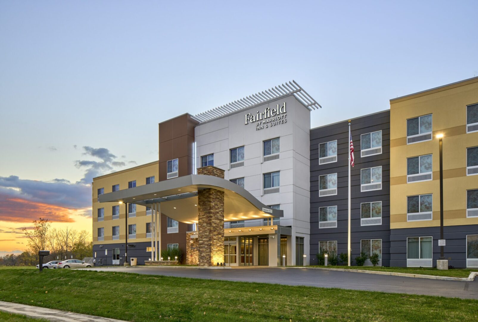 A hotel with a lot of windows and lights on the outside.