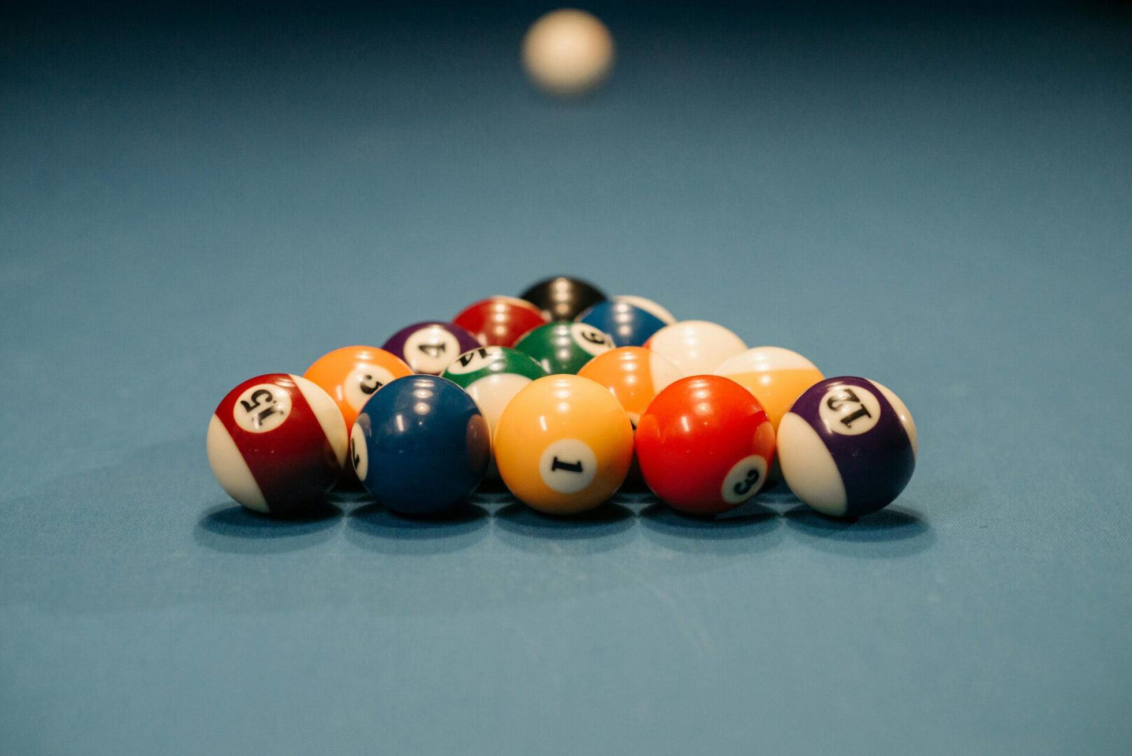 A pool table with many balls on it