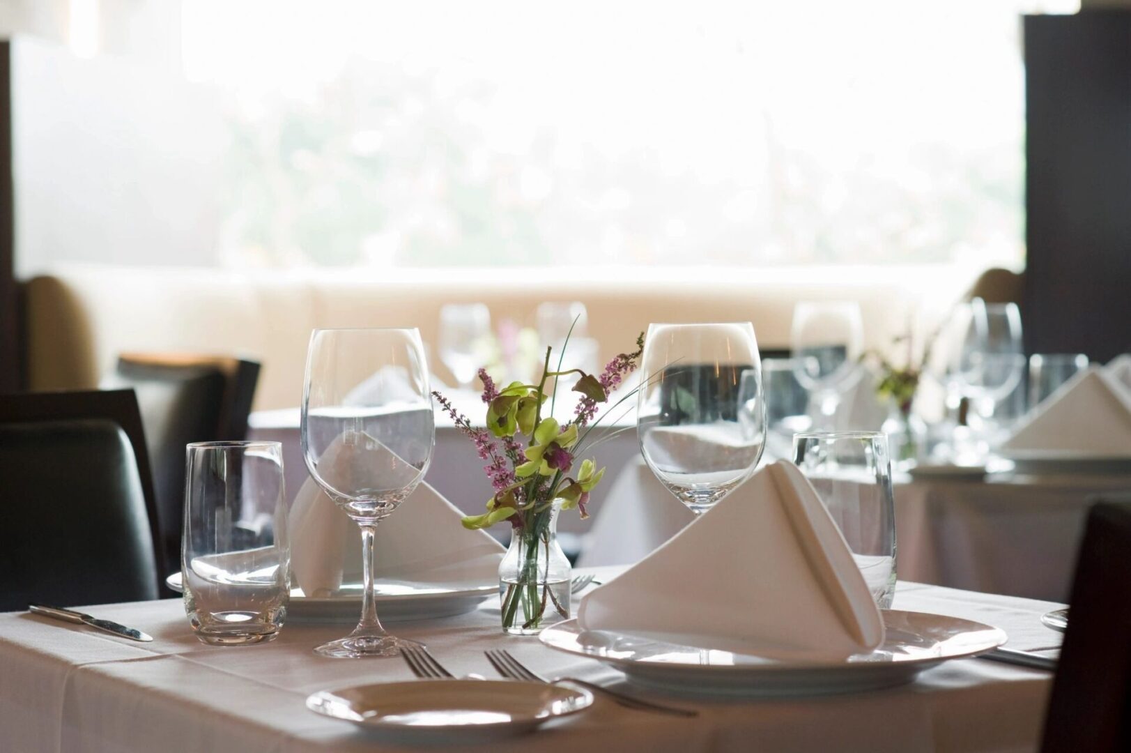 A table set with silverware and napkins on it.