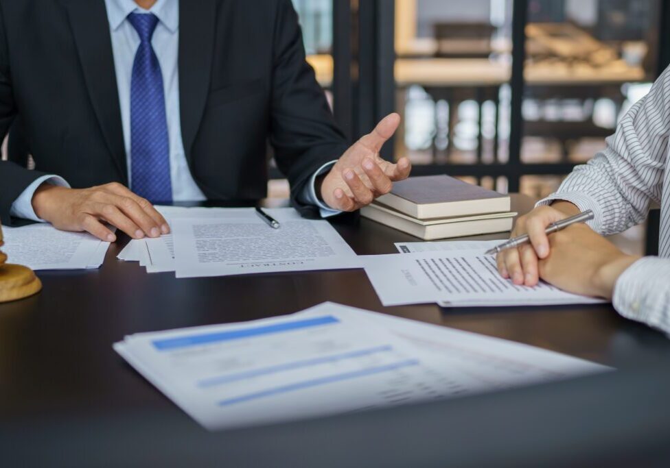 Lawyer and client reviewing contract.